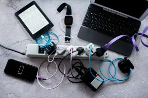 Many gadgets smartphone wireless headphones laptop smart watch camera battery and e book are charged on one power strip photo 1920w
